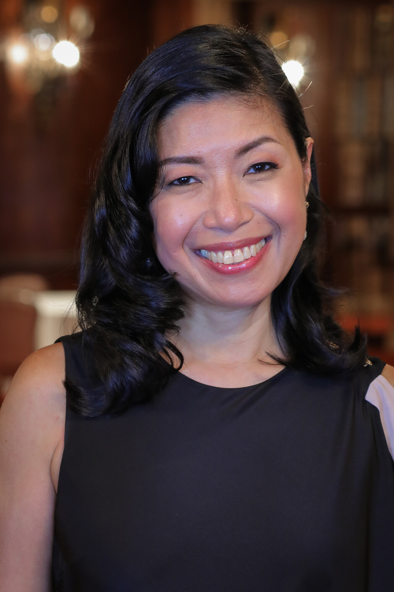 A photo of Odette Alcazaren-Keeley, an Asian woman with dark hair and a black dress.